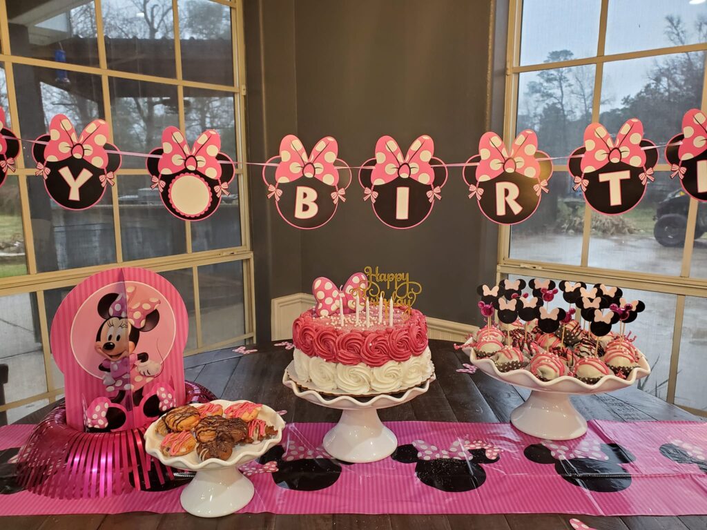 Minnie Mouse-themed birthday table with cake, cookies, and chocolate pops at The Lonesome Dove