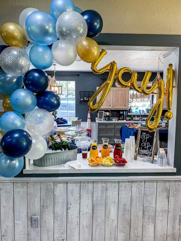 Event bar setup with balloons, juice, and champagne bottles